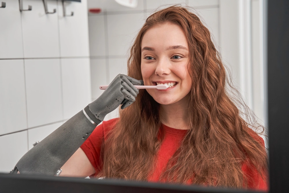 disabled women with prosthetic arm brushing teeth