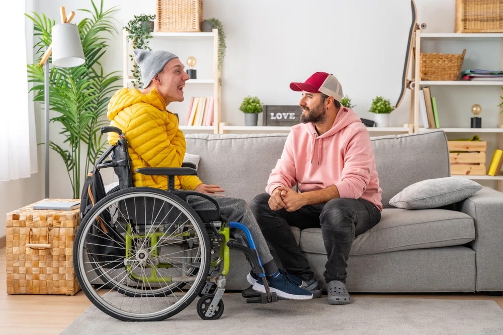 disabled boy with down syndrome ability and on wheelchair with a caretaker